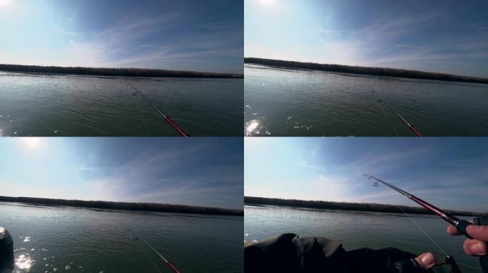 阳光明媚的天气里，垂钓者在河上的旋转竿上钓鱼