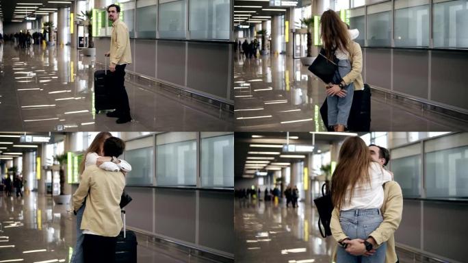 长胡子的年轻人带着手提箱，在机场等他的女朋友，经过长时间的分离，从商务旅行中飞回了家。男人拥抱女友并