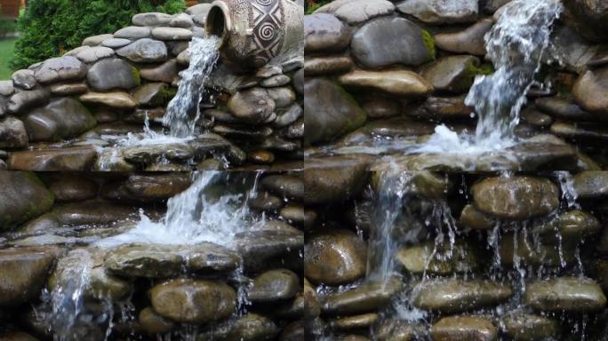 水从装饰喷泉中的amphorae在石头上流动