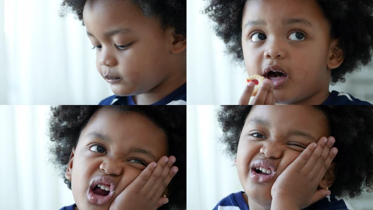 非裔美国人小男孩在吃饼干时牙痛