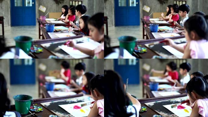 一群亚洲儿童学生在艺术教室里，在学校画画和信心。