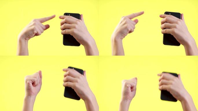 男子手持手机，使用手机，在工作室的黄色背景上显示拳头赢大拇指