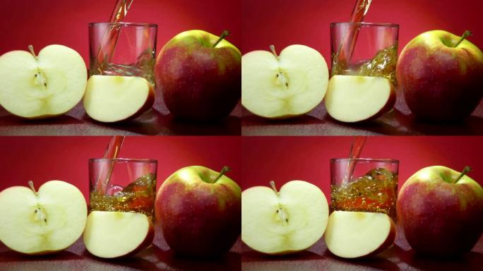 苹果汁倒在玻璃杯中，旁边是切成薄片的大成熟苹果