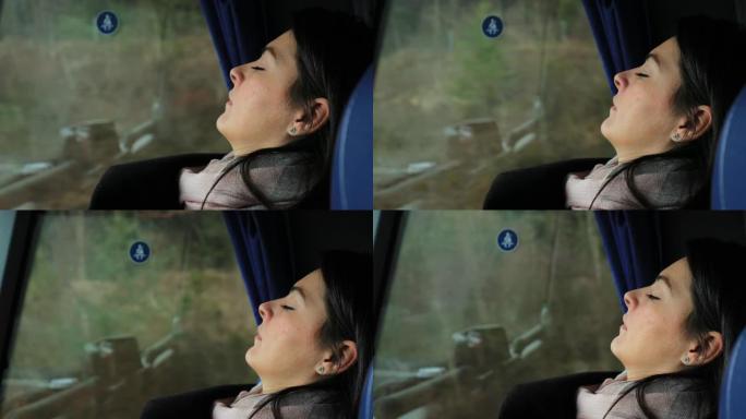 睡在公共汽车窗户旁边的女孩