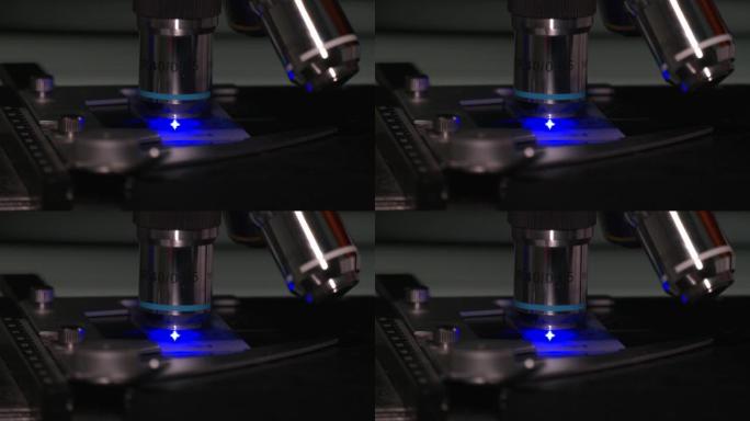 实验室用金属透镜拍摄显微镜的特写镜头。选择性聚焦技术员手持显微镜载玻片，用于医院的科学家诊断和病理科