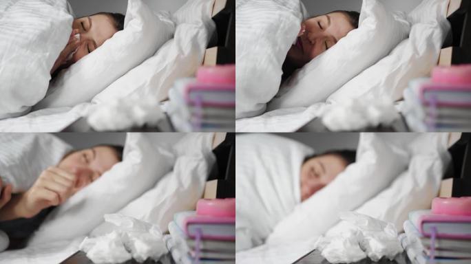 生病的女人流鼻涕躺在毯子下的床上，用纸巾吹鼻子。感冒，流感，过敏，灰尘，猫毛，鼻炎，体温过低，干燥的