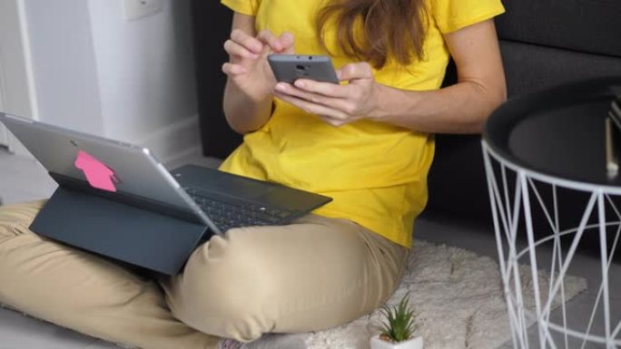 特写年轻的女商人在工作场所通过电话浏览互联网。女商人在家里在线检查电话内容的肖像。女自由职业者在远程