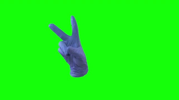 医生用蓝色手套的女性手显示两个手指的胜利标志。绿屏。特写