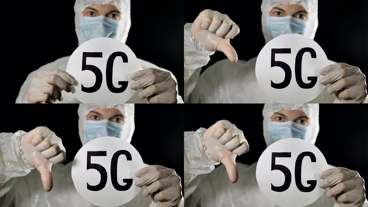 戴着医用口罩和防护服的男子举起5 g标志，露出拇指向下。5 g网络传播冠状病毒