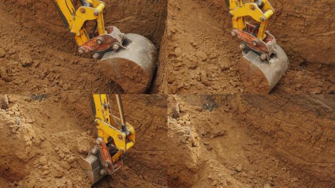 大型挖掘机铲斗从坑中提取土壤。建筑工地的挖掘工作