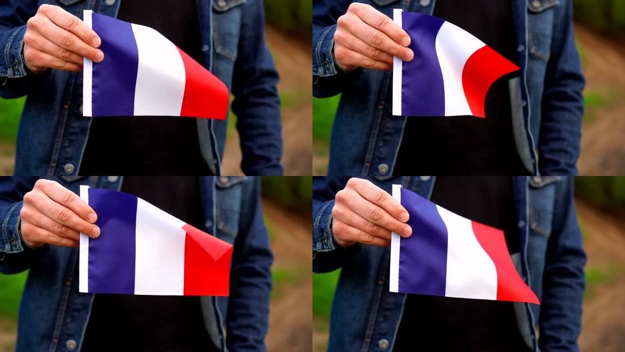 在户外举着法国国旗的人。独立日，或国定假日的概念