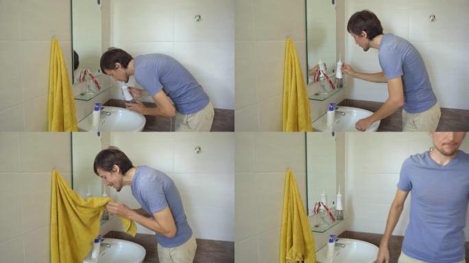 一名年轻人使用便携式水牙线器牙科口腔冲洗器清洁牙齿