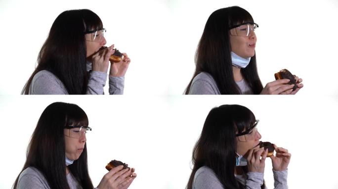 戴着医用口罩和护目镜的女人吃甜甜圈