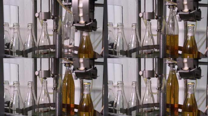 在工厂用玻璃瓶装瓶柠檬水。带玻璃瓶的传送带。输送机特写。生产饮料的过程。4K
