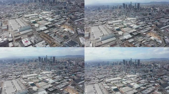 空中: 洛杉矶的仓库区缓慢倾斜，揭示了洛杉矶市中心的天际线