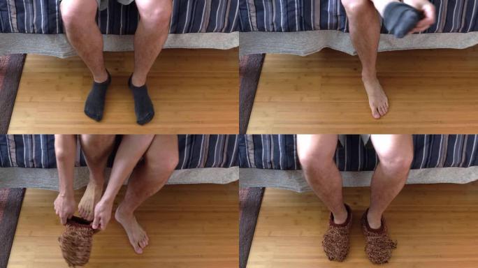 一个白人男性模特的特写镜头，坐在床边，从他的黑色脚踝袜子中换下来，穿上一些破旧的棕色针织拖鞋，然后走
