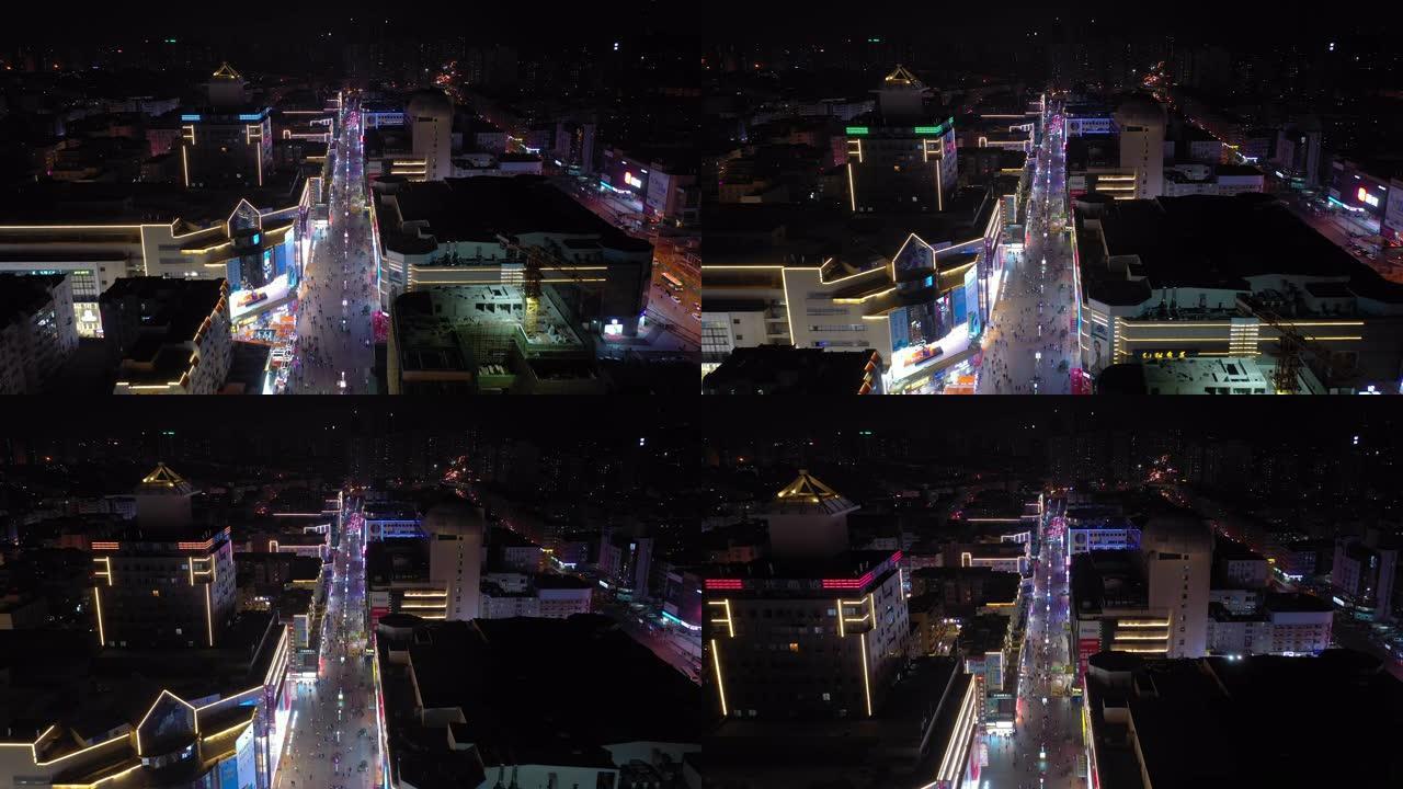 夜间照明青岛市著名行人拥挤街道空中全景4k中国