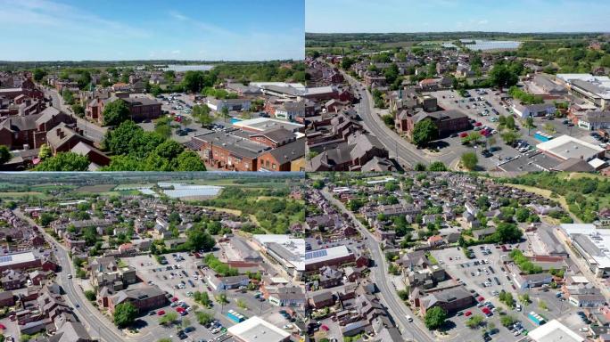 利兹西约克郡罗斯威尔镇中心的航拍画面显示了购物中心、消防局和住宅区，背景是阳光明媚的夏日