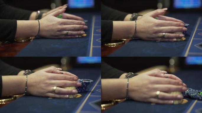 女性在赌场安全地拿着筹码。特写