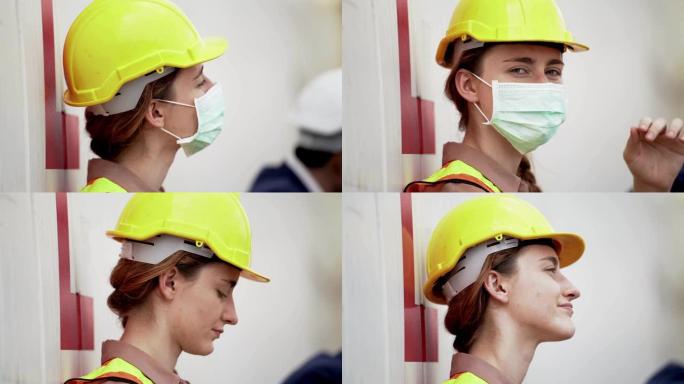 劳动女工下班后坐在室外仓库工厂放松。行业工人佩戴防护面罩面部和安全帽的概念。
