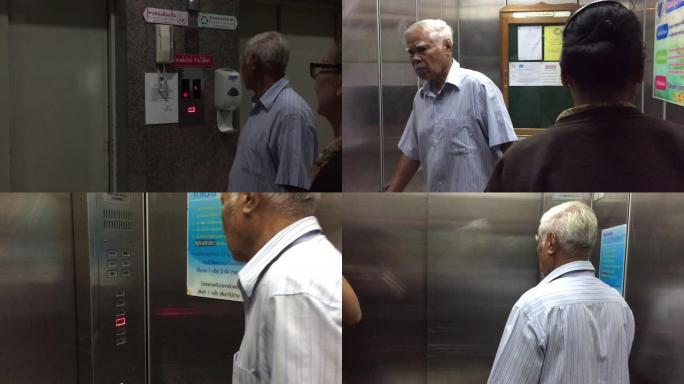 亚洲泰国老人按下电梯按钮