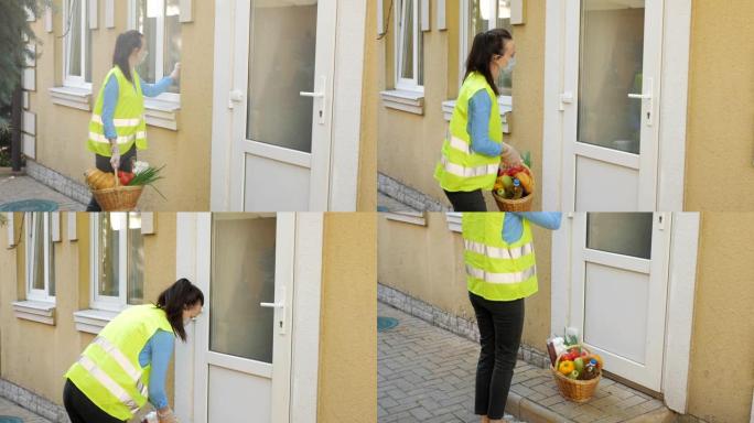 在检疫和严格的隔离中，一个志愿者女孩带着装满食物的篮子敲打着一位老人的房子。