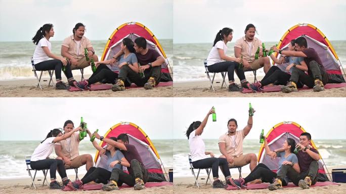 慢镜头拍摄一群年轻的亚洲朋友露营唱歌喝啤酒在露营旅行中的日落场景
