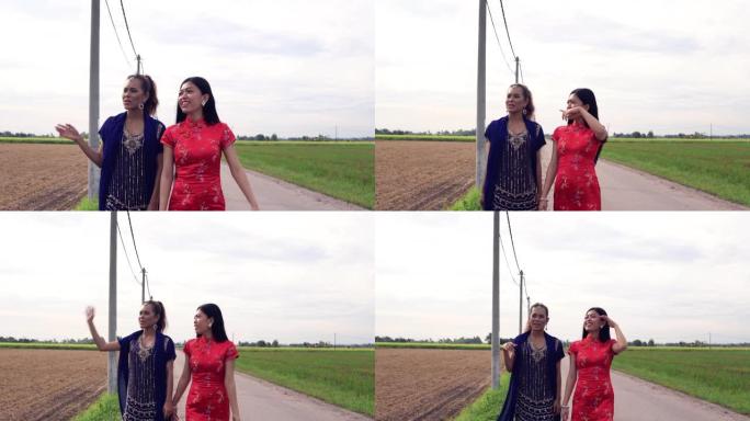 两个亚洲女孩在稻田边说边走
