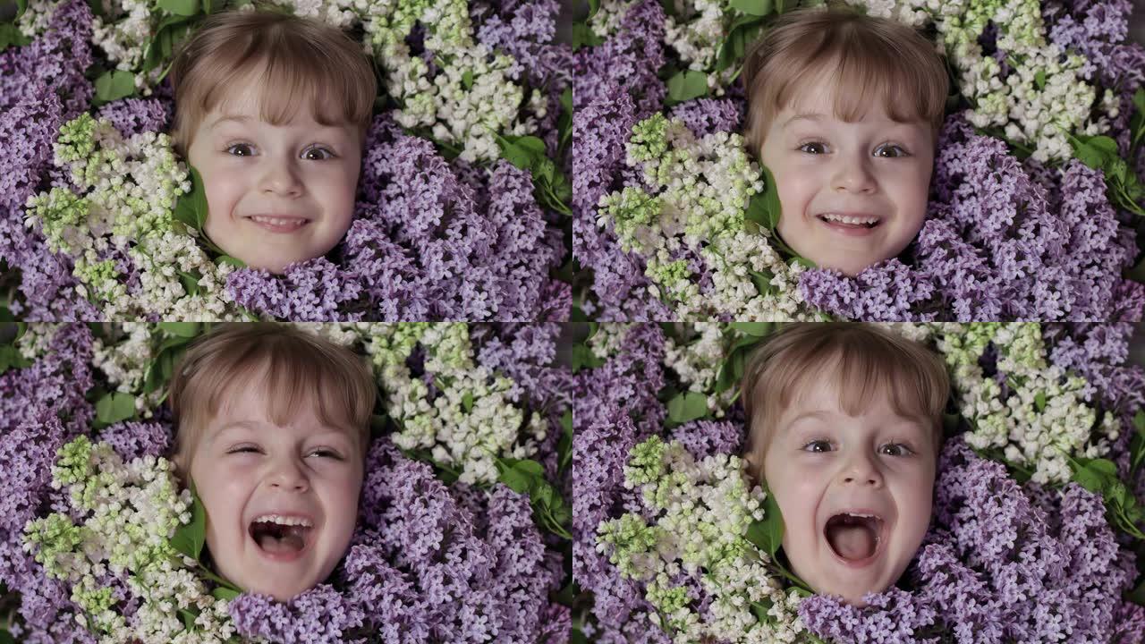 可爱的女孩孩子从她脸上的一束淡紫色花朵中寻找