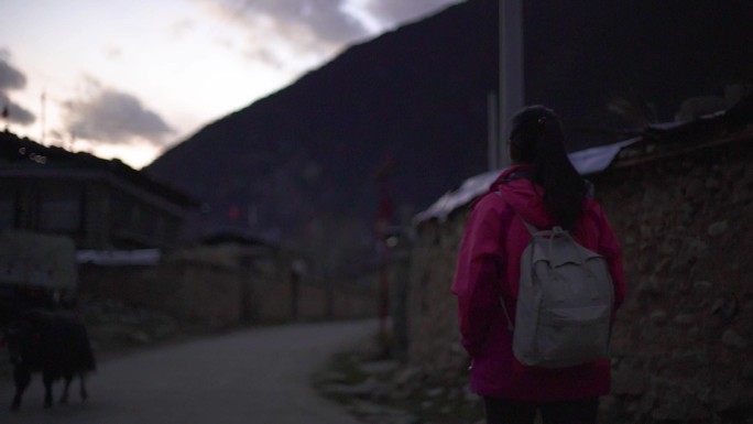 观观光徒步西藏村庄游玩穿冲锋衣的女生背影