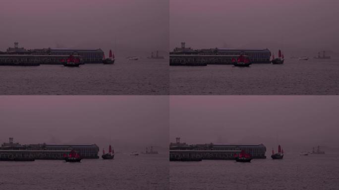 红色的Aqua Luna船在紫色的黄昏中离开香港中环天星码头