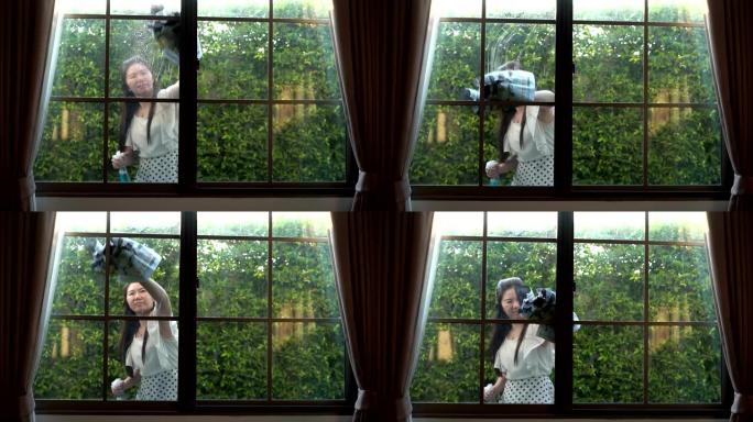 亚洲妇女用玻璃布擦屋开心脸