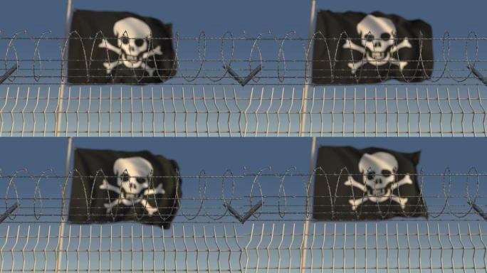 铁丝网反对散焦的挥舞着欢乐的罗杰海盗旗
