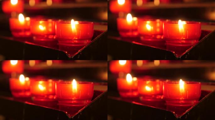 天主教祈祷红杯蜡烛在烛台慢动作