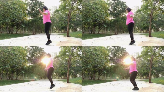 亚洲高加索胖女孩漂亮的脸穿着粉红色的运动服，早上在公园跳绳运动，保健运动减肥