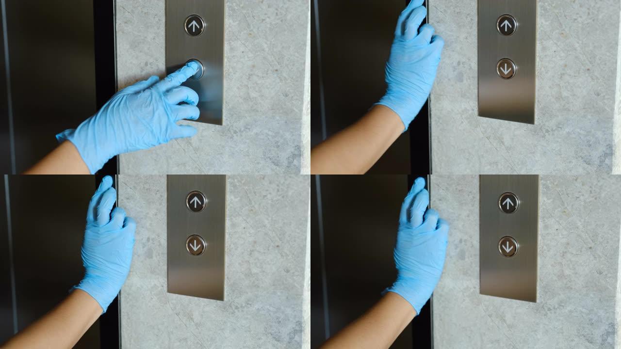 一只戴着防护橡胶手套的手正在按下电梯按钮。日冕病毒新型冠状病毒肺炎流行的感染预防与控制。
