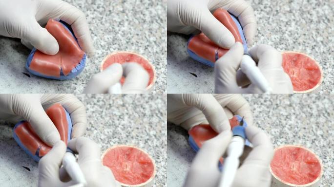 牙科技师在牙科实验室制作假牙的特写