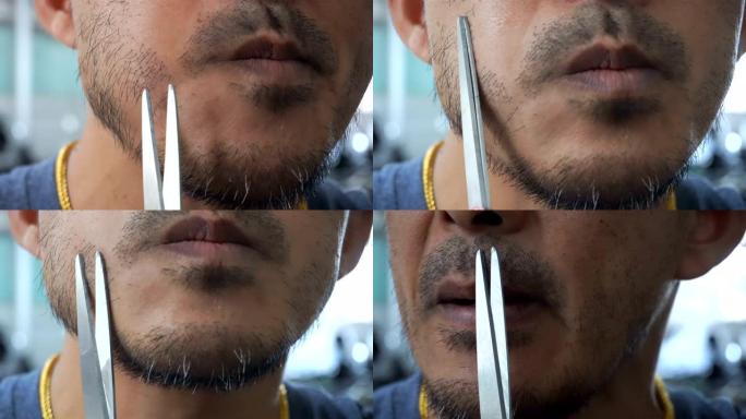 一个人用一把剪刀修剪胡须。