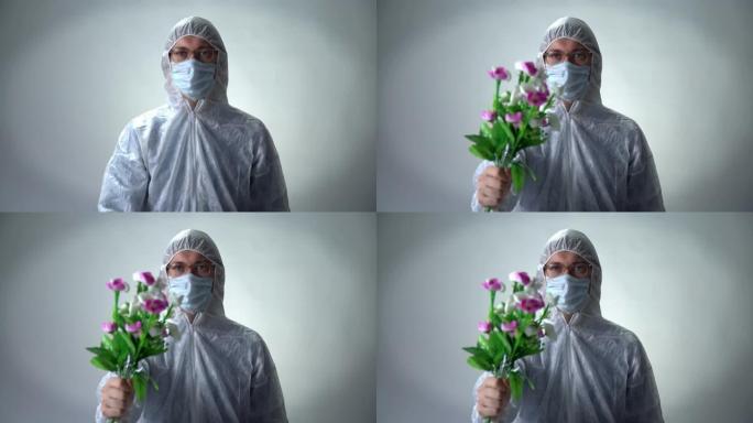 一名身穿防护服，医用口罩和眼镜的男子在白色背景上献花