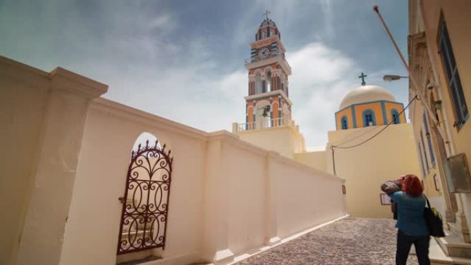 阳光明媚的日子著名的圣托里尼岛伊亚镇教堂全景4k延时希腊