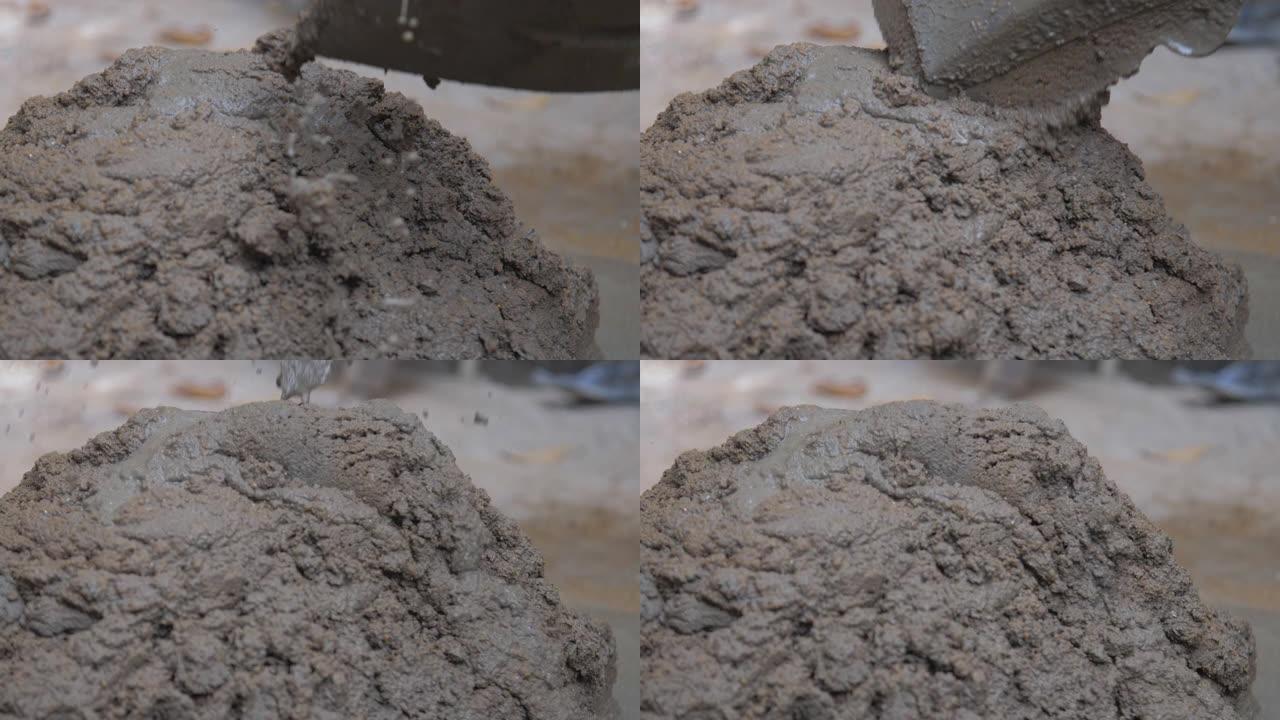 建筑工人混合湿灰水泥持铲