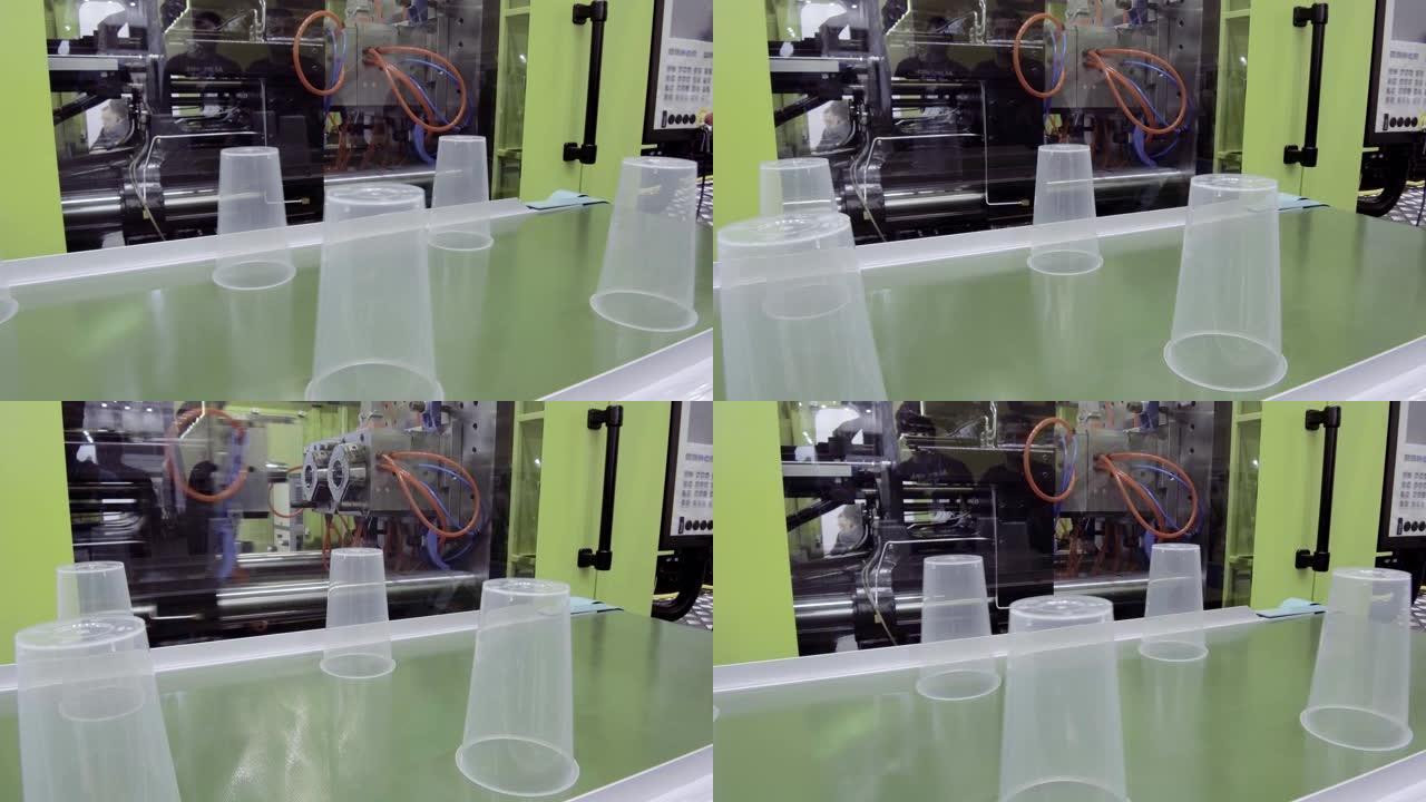 机器人的手在传送带上设置塑料杯