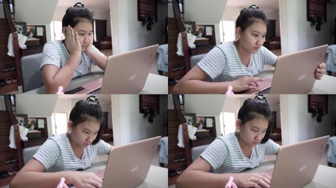 年轻的亚洲妇女使用笔记本电脑学习通话视频会议与老师在家里的客厅。
