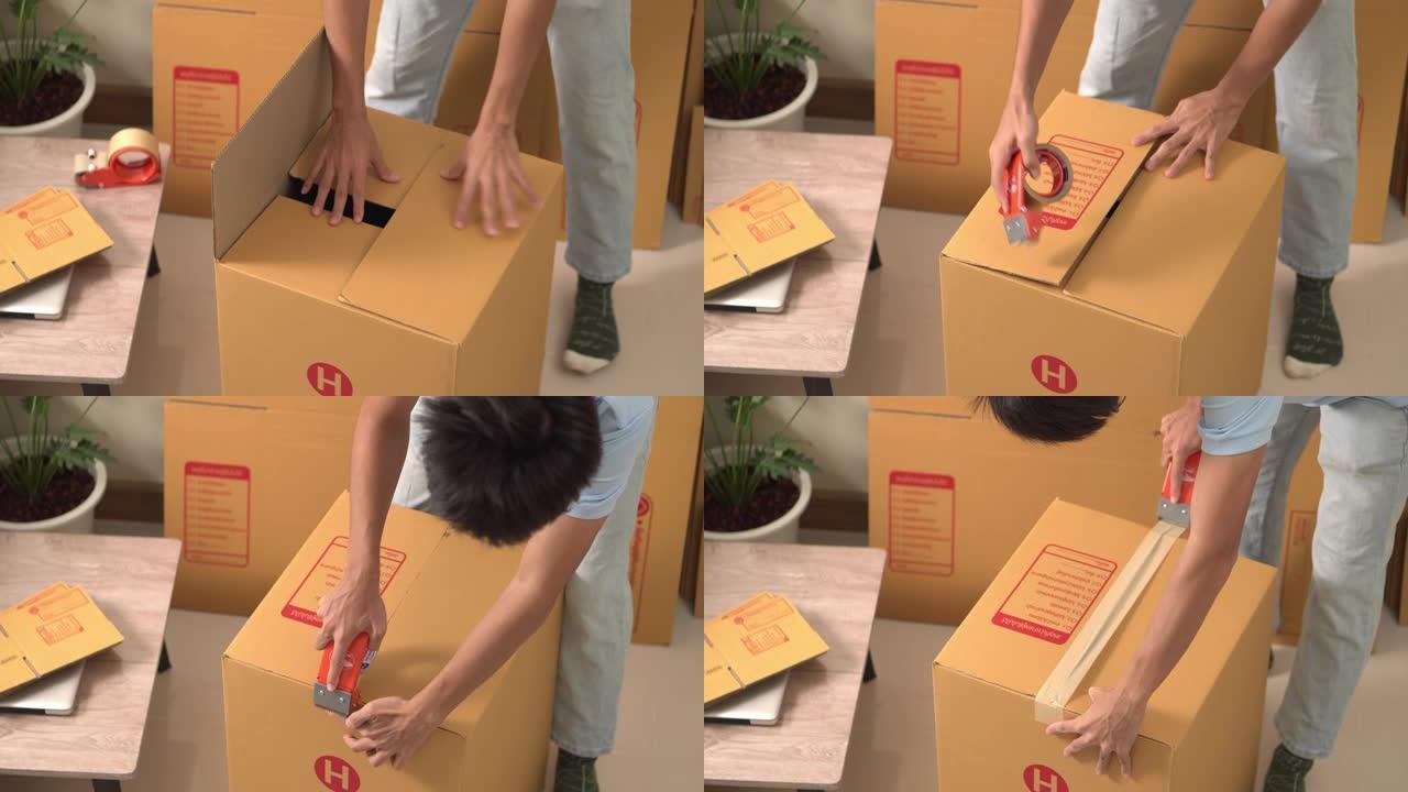 一名男子正在包好包装盒以便送货。