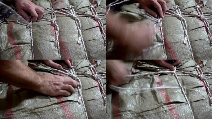 男性手解开包装袋上绳索的4k视图