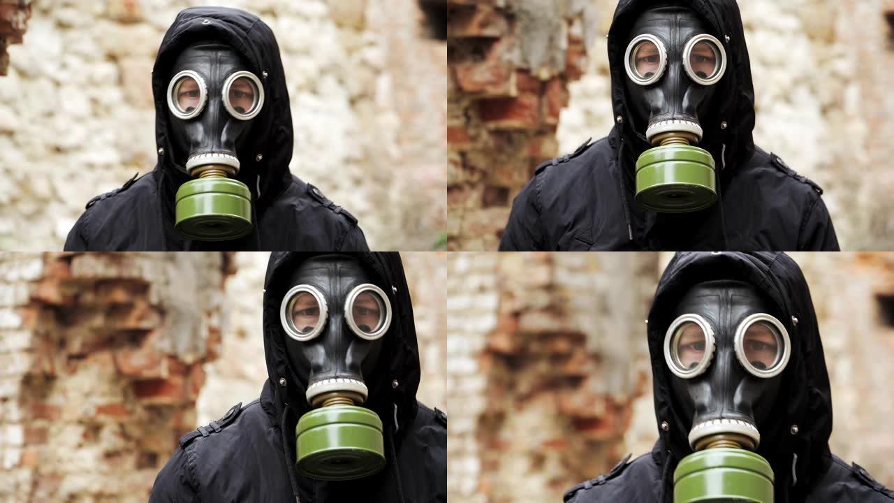 肖像。特写。戴防毒面具的人在一栋废弃建筑的碎片中。后世界末日世界。跟踪者概念，核化学战争后的幸存者。
