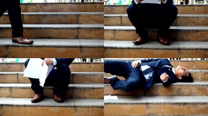 劳累过度的年轻亚洲商人躺在楼梯上，感到筋疲力尽。