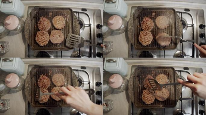一个女人在家里煮四个汉堡包时的慢动作视频