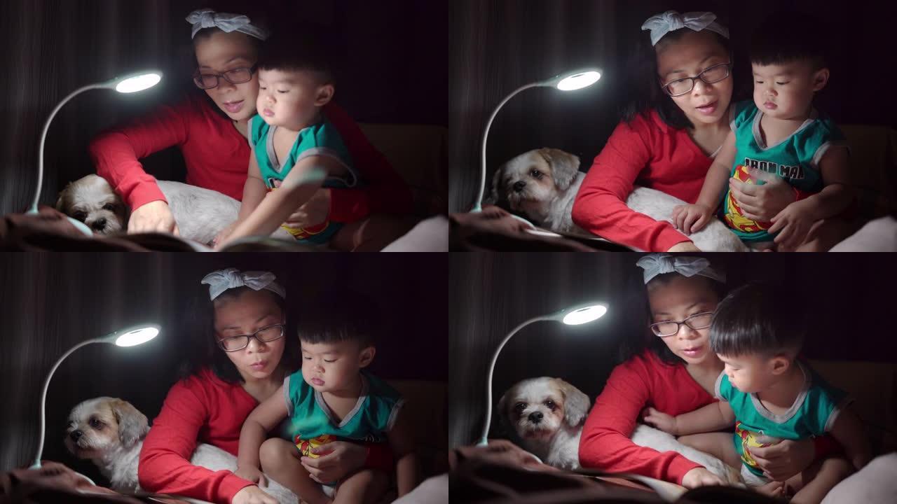 亚洲妈妈和儿子在家床上看书