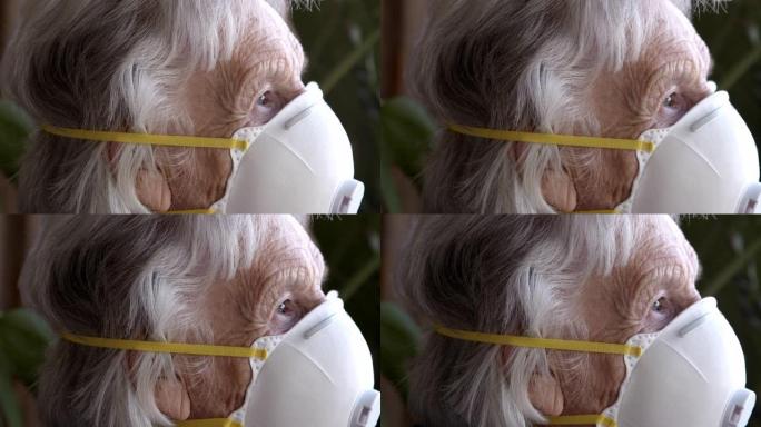 悲痛欲绝的老年高加索妇女的特写镜头看着窗外感到孤独戴着n95防护口罩防止COVID传染性非典型肺炎传